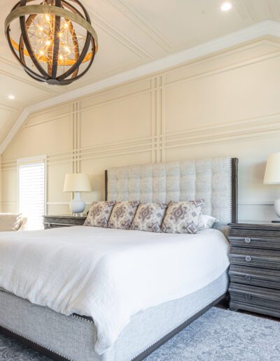 Elegant bedroom with a large bed, ornate light fixtures, and classic decor.